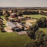 Aerial view of countryside farm with green fields.