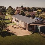 Rural building with car park and trees