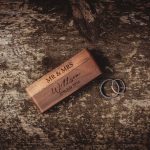 Wooden wedding box and two wedding rings on wood.