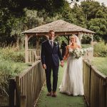 Bride and groom walking in garden after wedding