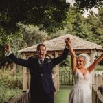 Joyful wedding couple celebrates outdoors