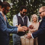 Guests holding confetti at an outdoor wedding.