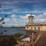 Normanton Church by Rutland Water under blue sky