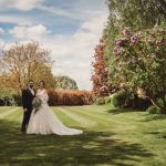 Bride and groom in a sunny garden.