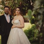 Bride and groom in wedding attire outdoors