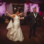 Wedding couple dancing joyfully on the dance floor.