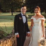 Bride and groom holding hands outdoors