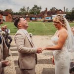 Bride and groom exchanging vows outdoors