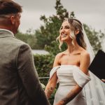 Bride and groom exchanging vows outdoors at wedding.