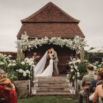 Wedding ceremony kiss in garden setting