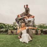 Wedding party fun pose in garden setting