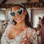 Bride smiling, wearing heart-shaped sunglasses