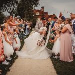 Bride and groom kissing at wedding ceremony.