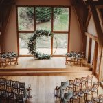 Rustic wedding ceremony setup with floral arch.