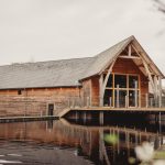 Wooden barn by tranquil lakeside