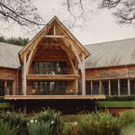 Rustic wooden building surrounded by greenery.