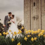 Wedding couple with castle and daffodils background