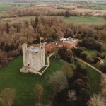 Aerial view of an English castle and gardens.