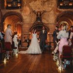 Couple married in candle-lit historic chapel.