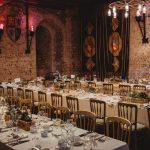 Elegant medieval banquet hall setup with long tables.