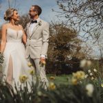 Bride and groom smiling in spring garden