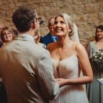 Bride and groom exchanging vows at wedding ceremony.