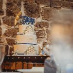 Wedding cake with castle design and floral decor.