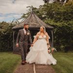 Bride and groom walking in garden