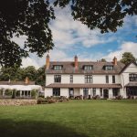 Large countryside house with garden and trees