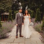 Bride and groom in garden wedding setting.