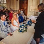 Wedding couple and guests in ceremony room