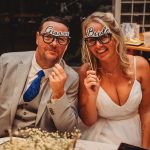 Bride and groom with fun glasses at wedding