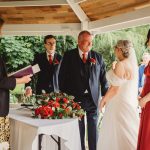 Wedding ceremony with bouquet and guests.