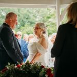 Bride and groom exchanging vows at outdoor wedding