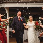 Joyful wedding ceremony with confetti and flowers.