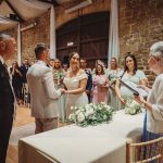 Couple exchanging vows in a rustic wedding ceremony.