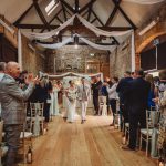 Bride and groom exiting ceremony with applause