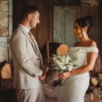 Bride and groom smiling in rustic setting