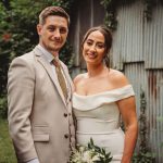 Happy couple posing in garden setting.