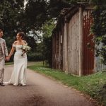 Bride and groom walking on garden path