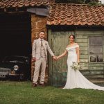 Bride and groom holding hands outdoors