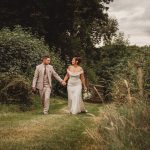 Bride and groom walking in garden