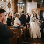 Bride walking down the aisle with father.