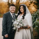 Bride and groom by a scenic pond