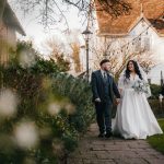 Bride and groom walking in garden