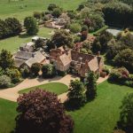 Aerial view of country manor and gardens.