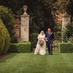 Bride and groom walking in garden