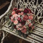 Floral bouquet on ornate garden bench