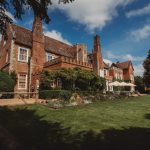 Historic red brick manor house with garden