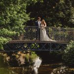 Bride and groom on garden bridge